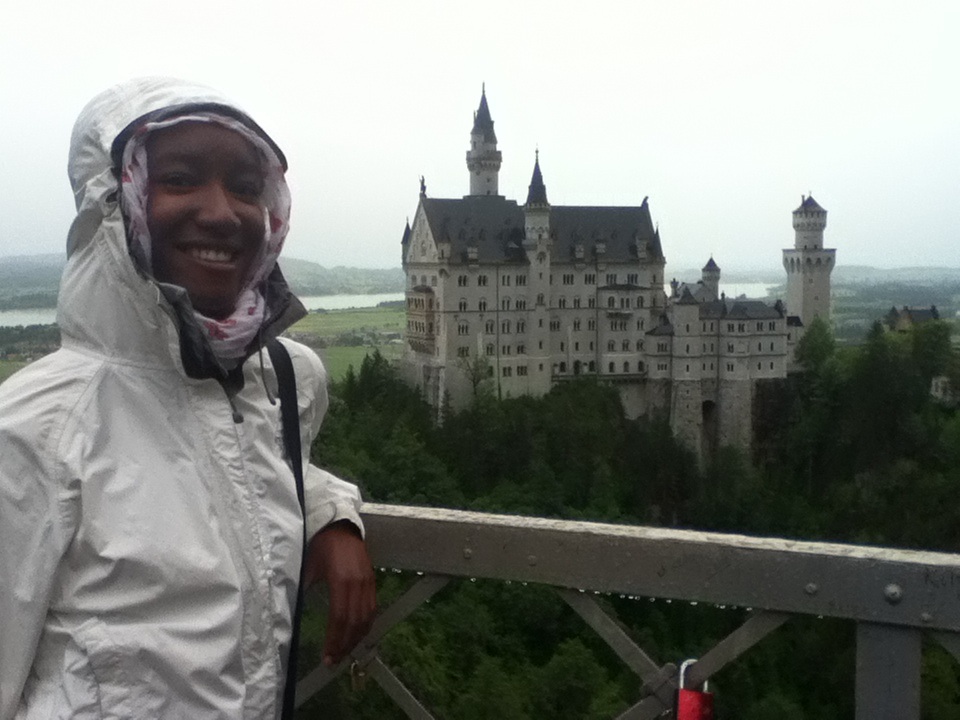 lady standing on a bridge with Neuschwanstein castle in the backdrop