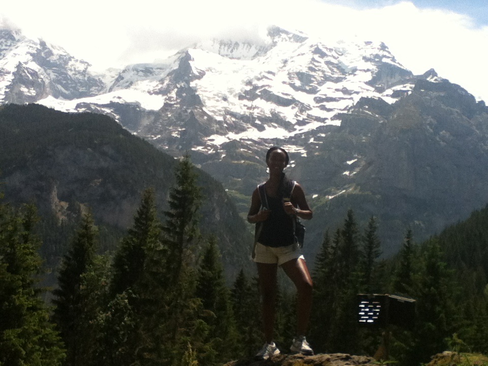 a cool lady standing at a mountain viewpoint
